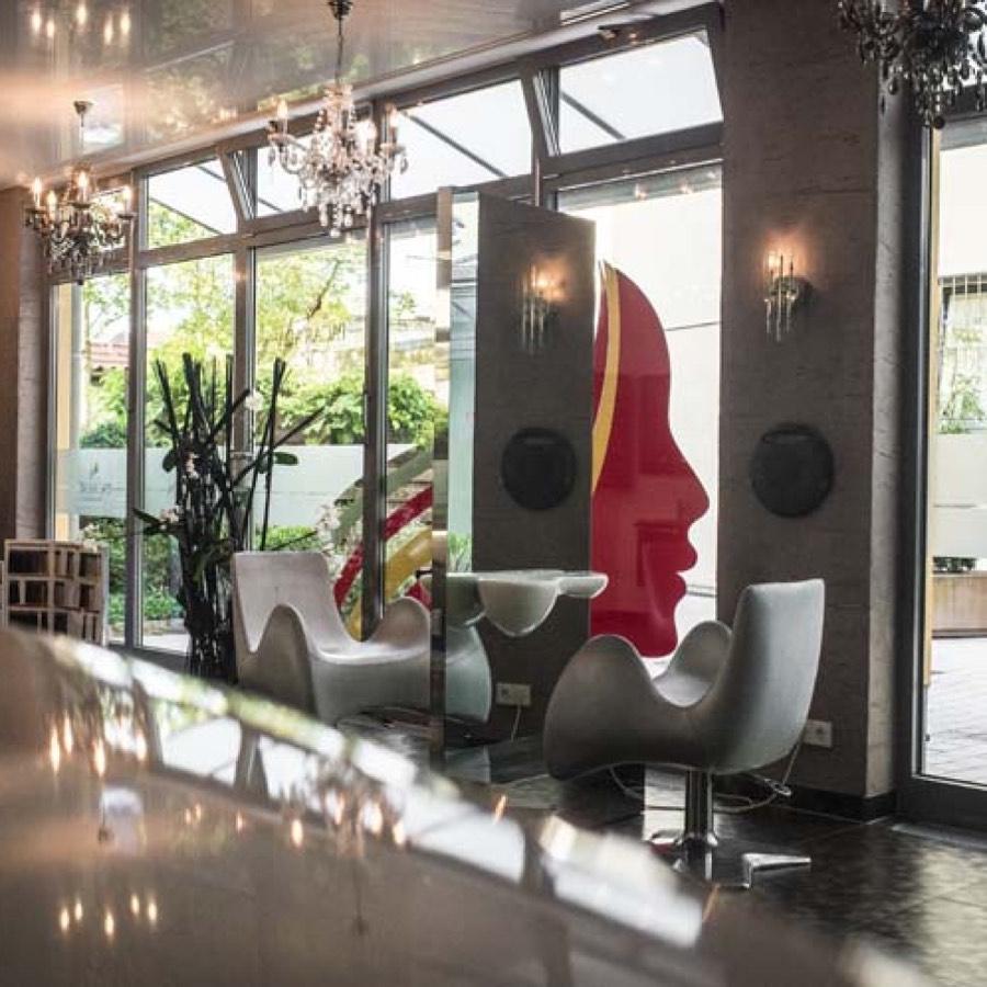 Seating area with wall artwork and chandeliers